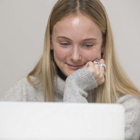 Oxford Media & Business School - girl smiling at computer